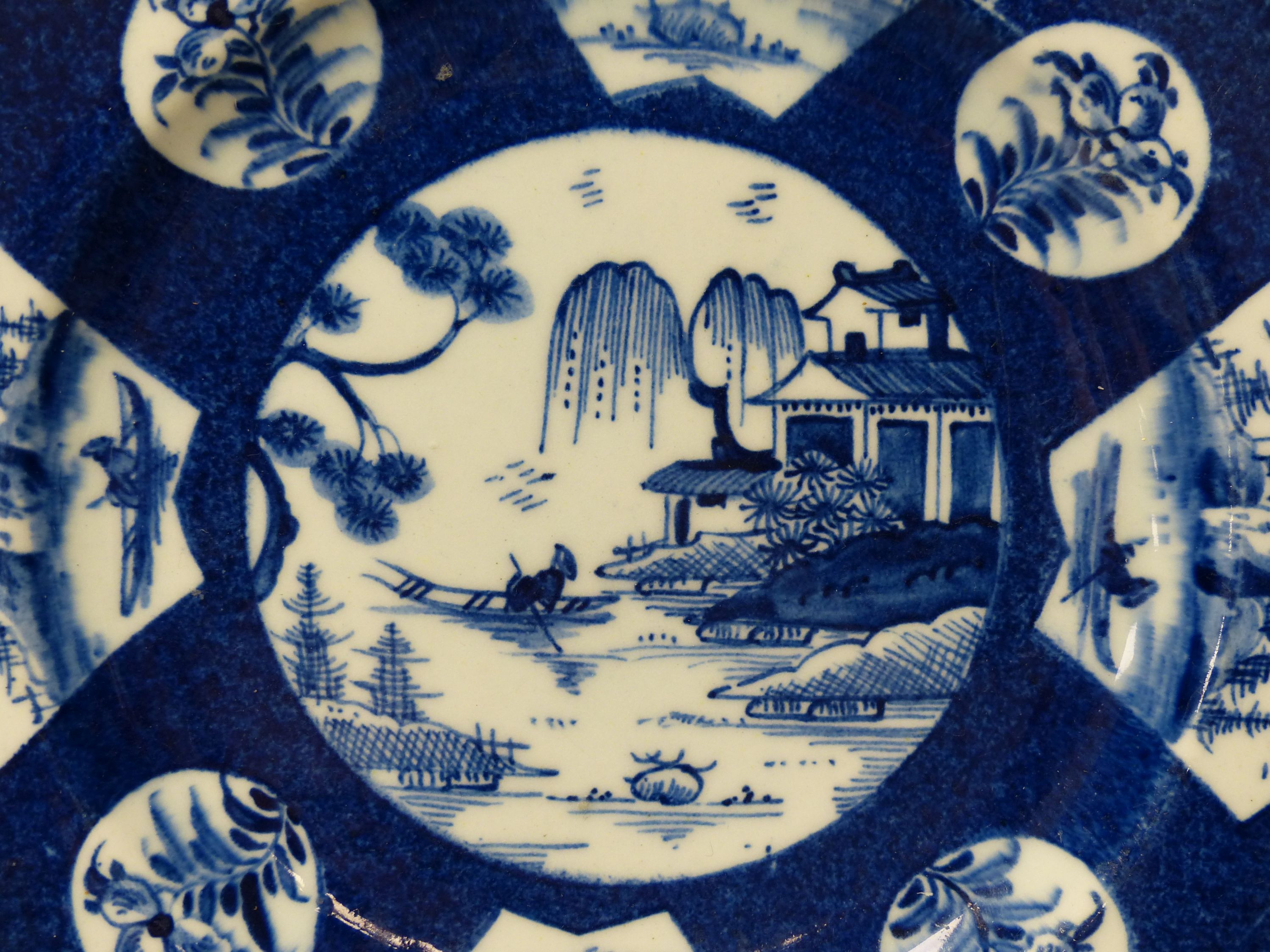 A Bow circular plate painted with landscapes, c.1757, six character mark, 20cm diameter